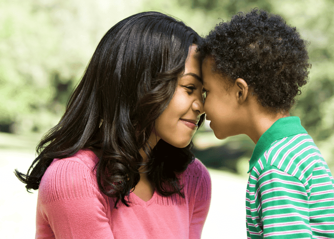 a woman and a boy touching noses