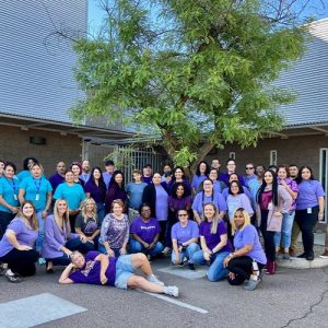 team of people in front of building | Get Involved | Shelter Team