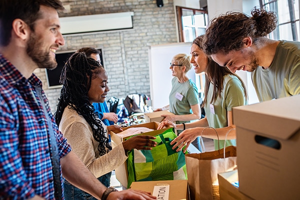 Group Of Volunteers With Working In Community Charity Donation Center