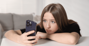 Stay Strong - Woman looking at her phone